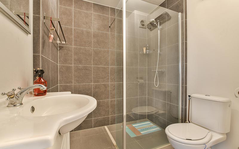 Custom walk-in shower tile installation with niche and bench